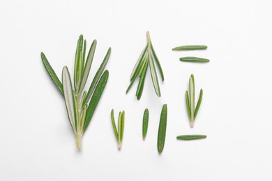 Photo of Sprigs of fresh rosemary on white background, flat lay