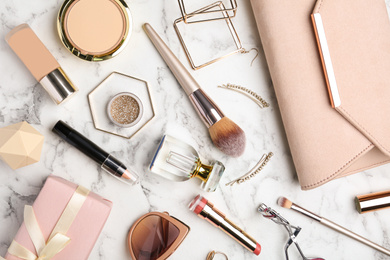 Photo of Flat lay composition with different luxury makeup products and accessories on white marble table