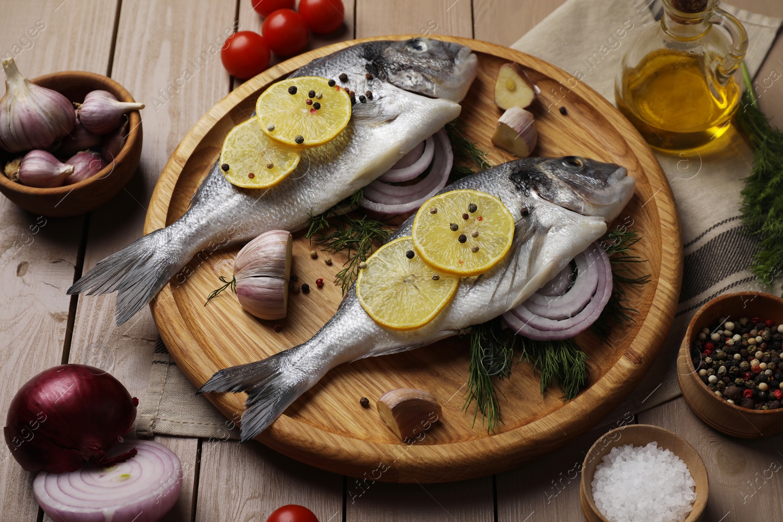 Photo of Composition with raw dorado fish and spices on wooden table