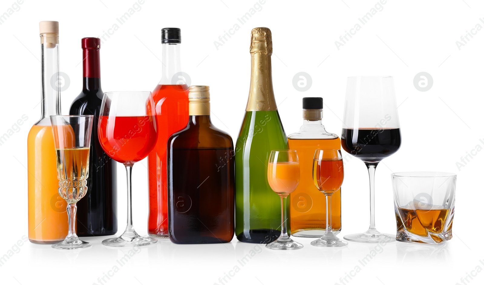 Photo of Bottles and glasses with different alcoholic drinks isolated on white