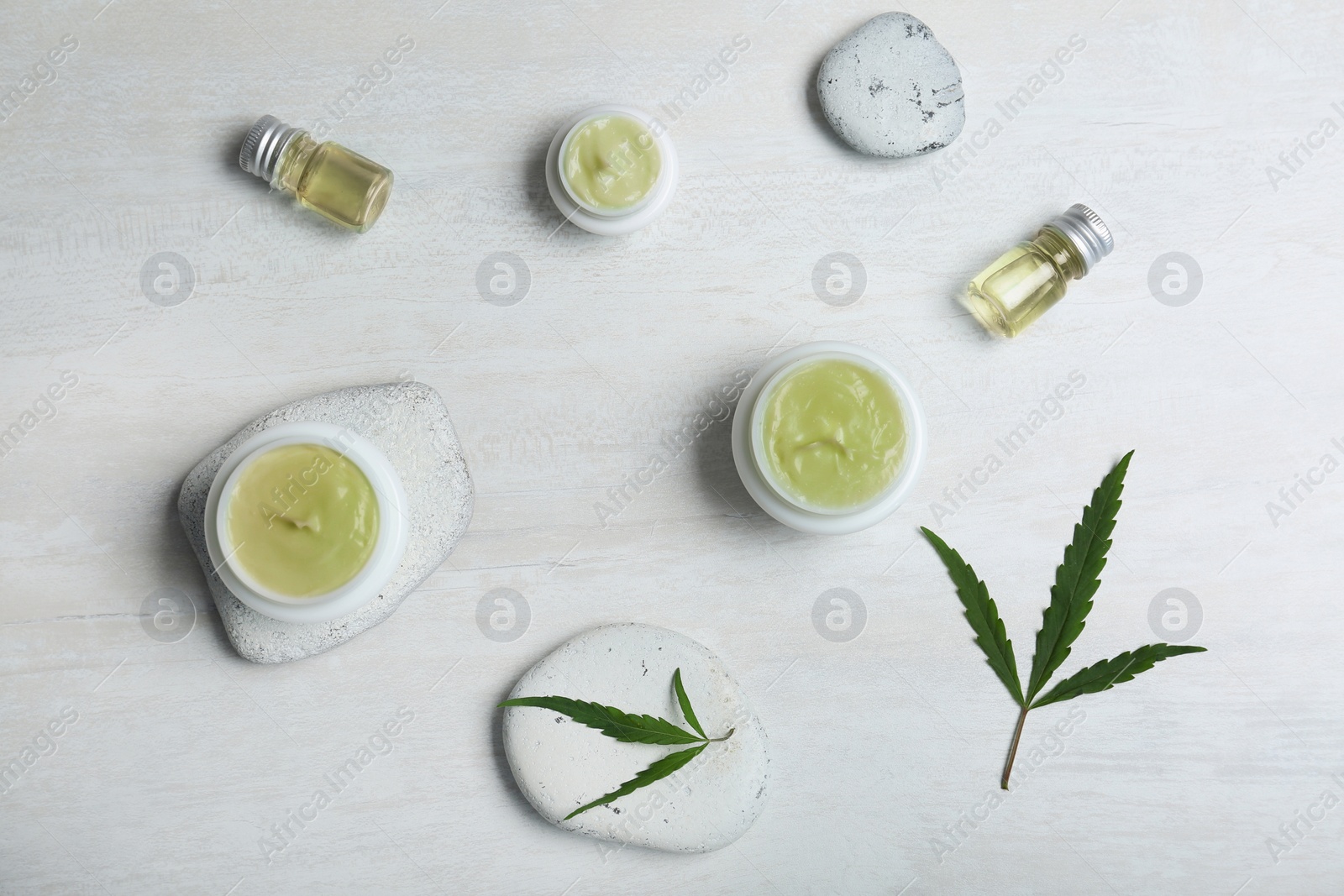 Photo of Flat lay composition with hemp lotion on light background