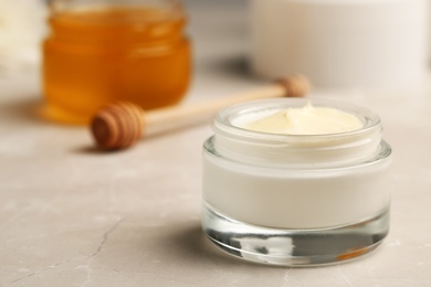 Photo of Closeup view of hand cream jar on gray background