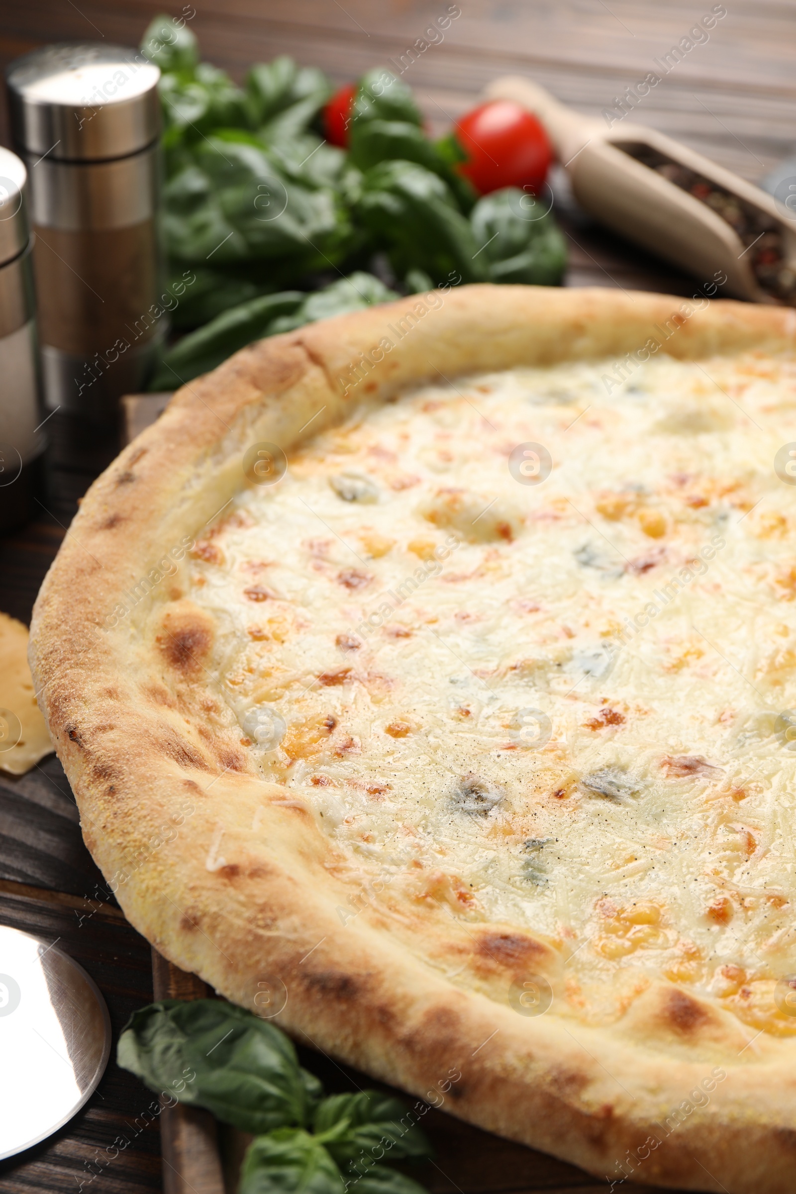 Photo of Delicious cheese pizza on wooden table, closeup