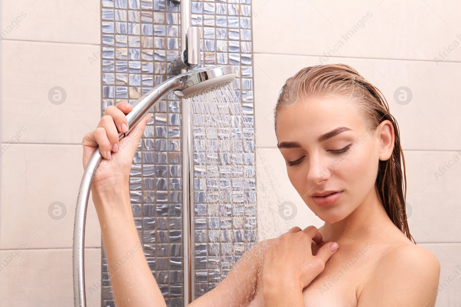 Photo of Beautiful young woman taking shower at home