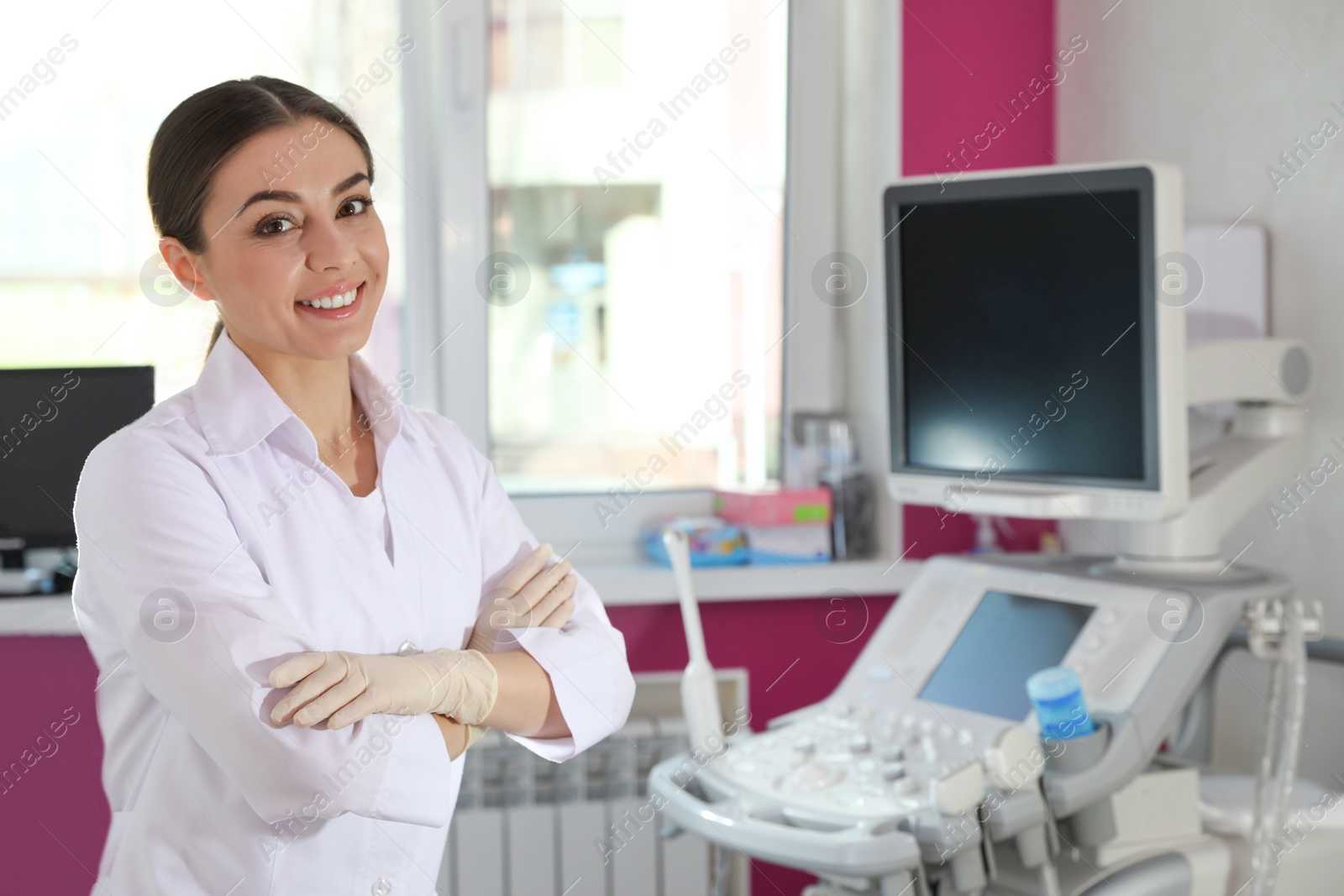 Photo of Sonographer near modern ultrasound machine in clinic, space for text