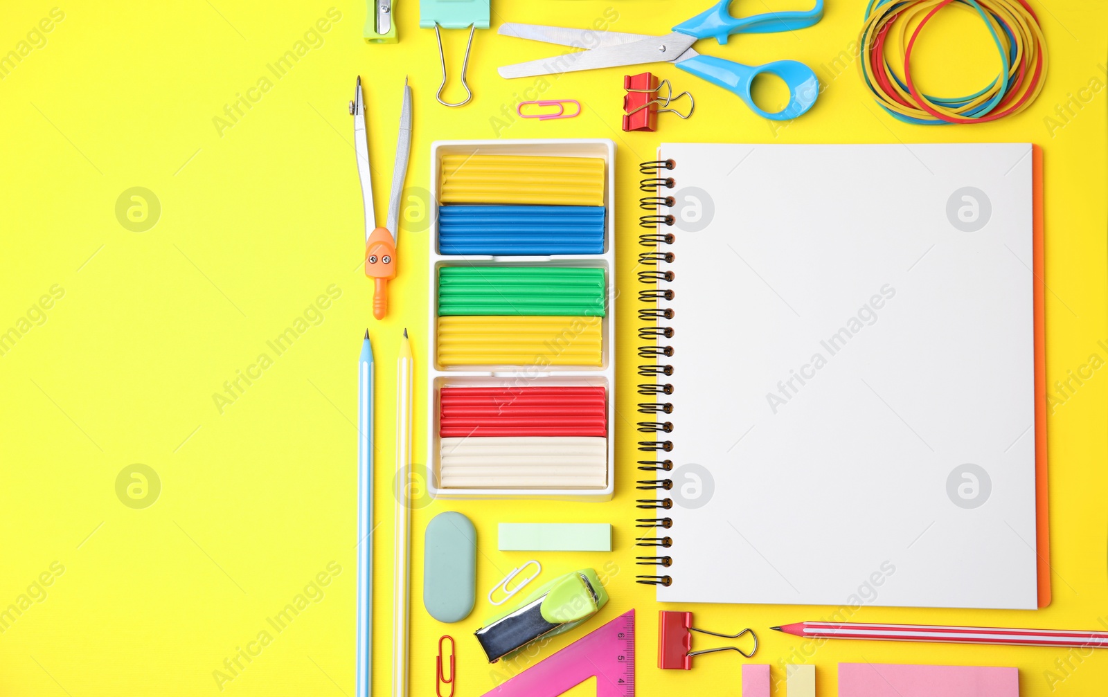 Photo of Flat lay composition with different school stationery on yellow background, space for text. Back to school