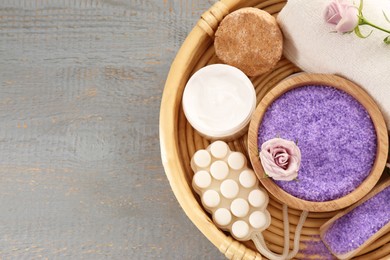 Photo of Sea salt and different spa products on light grey wooden table, top view. Space for text