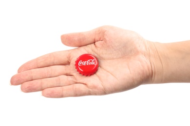 Photo of MYKOLAIV, UKRAINE - NOVEMBER 15, 2018: Woman holding Coca Cola lid on white background