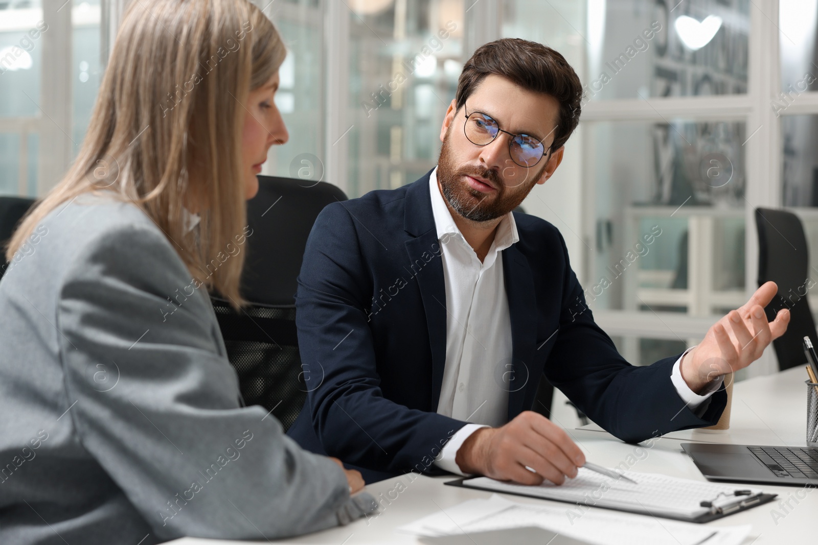 Photo of Lawyers working together at table in office