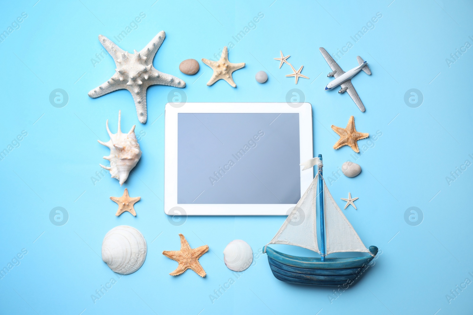 Photo of Flat lay composition with modern tablet on light blue background. Space for text