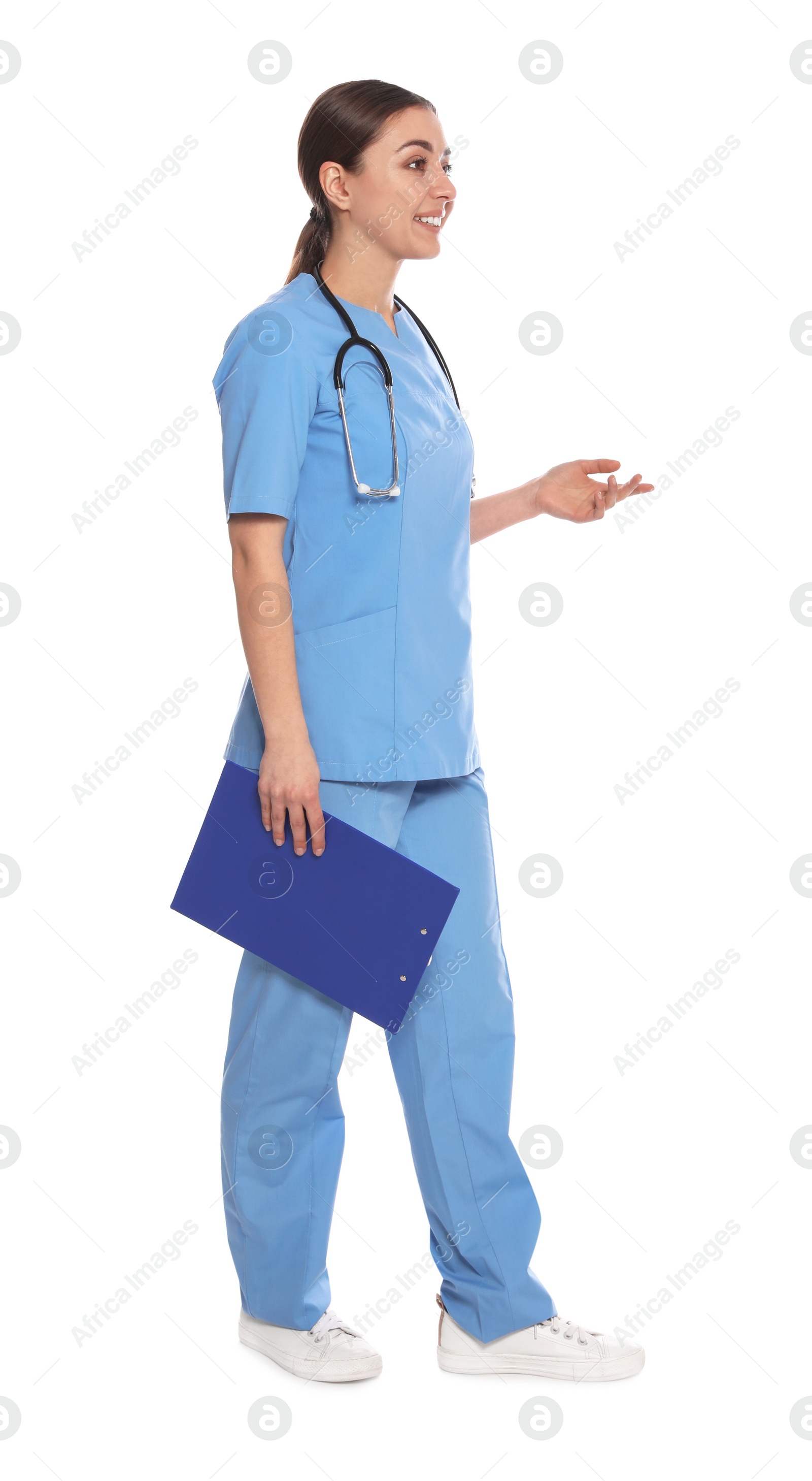 Photo of Full length portrait of medical doctor with clipboard and stethoscope isolated on white