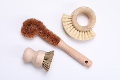 Photo of Cleaning brushes on white background, flat lay