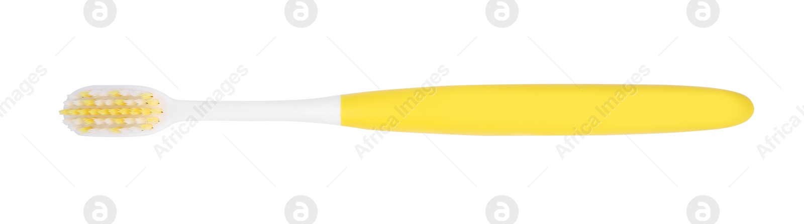 Photo of Yellow plastic toothbrush isolated on white, top view