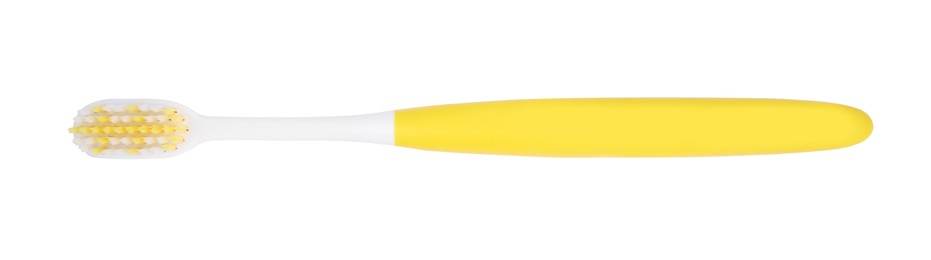 Photo of Yellow plastic toothbrush isolated on white, top view