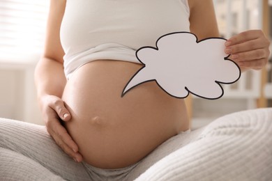 Photo of Pregnant woman with empty paper thought cloud indoors, closeup. Choosing baby name