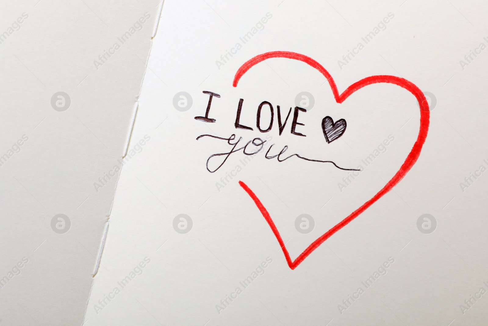 Photo of Phrase I Love You and heart drawings on notebook page