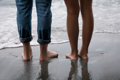 Photo of Young couple on beach near sea, closeup