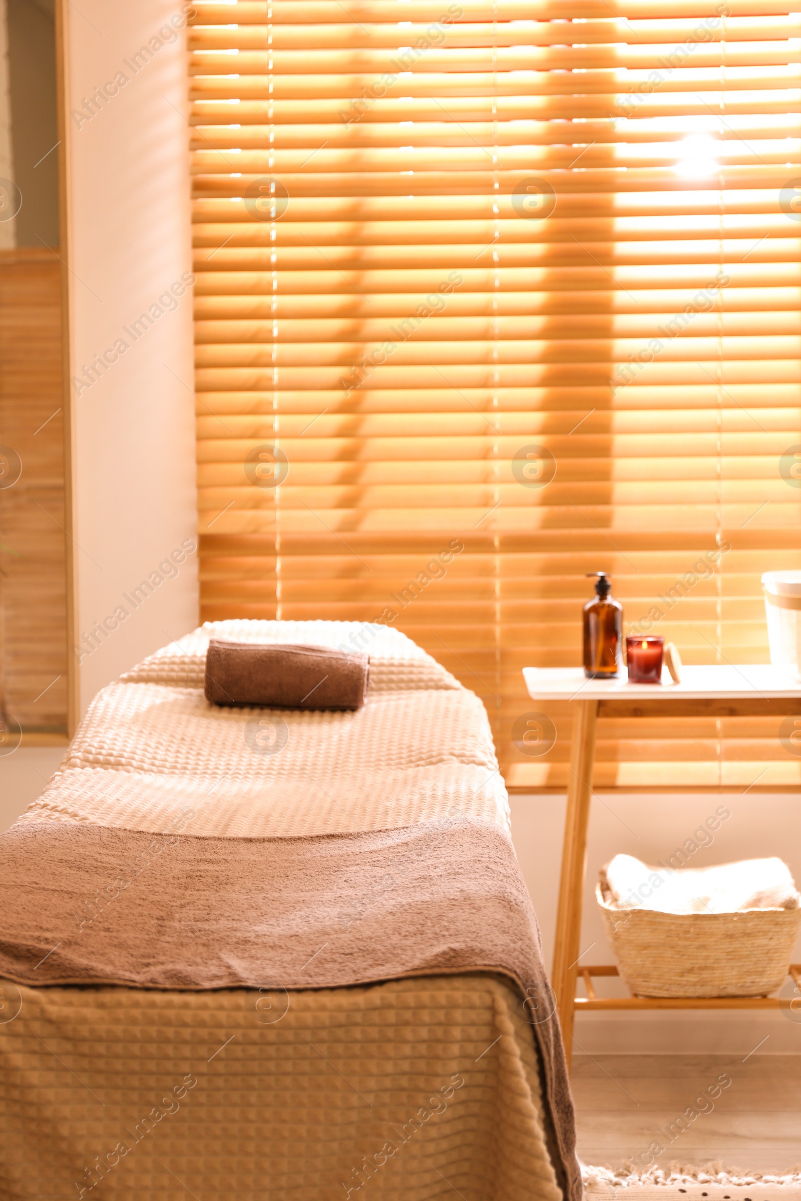 Photo of Stylish massage room interior in spa salon