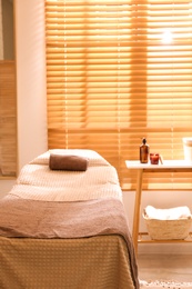 Photo of Stylish massage room interior in spa salon