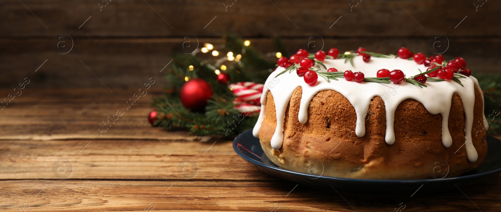 Image of Traditional homemade Christmas cake on wooden table, space for text. Banner design