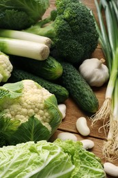 Different fresh ripe vegetables on wooden table