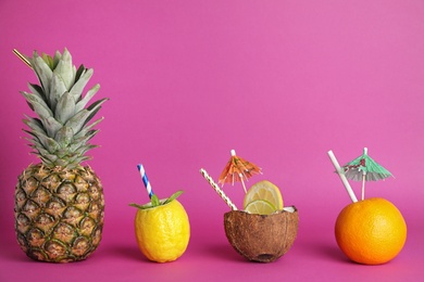 Photo of Creative image of summer cocktails made with fruits and coconut on color background