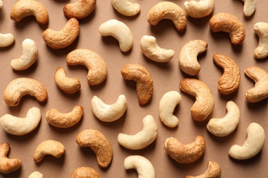 Photo of Tasty cashew nuts on color background, flat lay