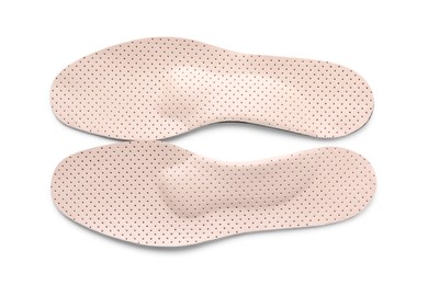 Beige orthopedic insoles isolated on white, top view