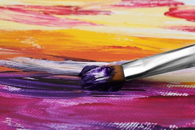 Photo of Painting with colorful oil paints on white canvas, closeup view