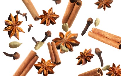 Image of Aromatic anise stars, cinnamon, cloves and cardamom falling on white background