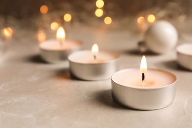 Photo of Beautiful burning wax candle on table, closeup