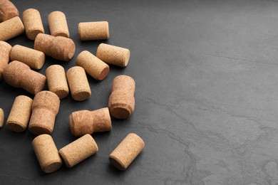 Wine bottle corks on black table. Space for text