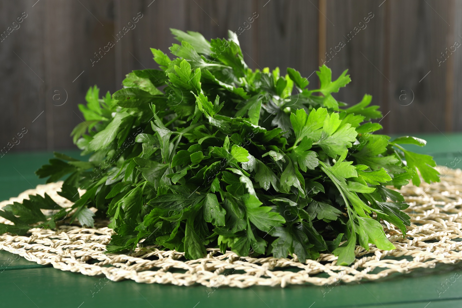 Photo of Fresh green parsley on wooden table, closeup