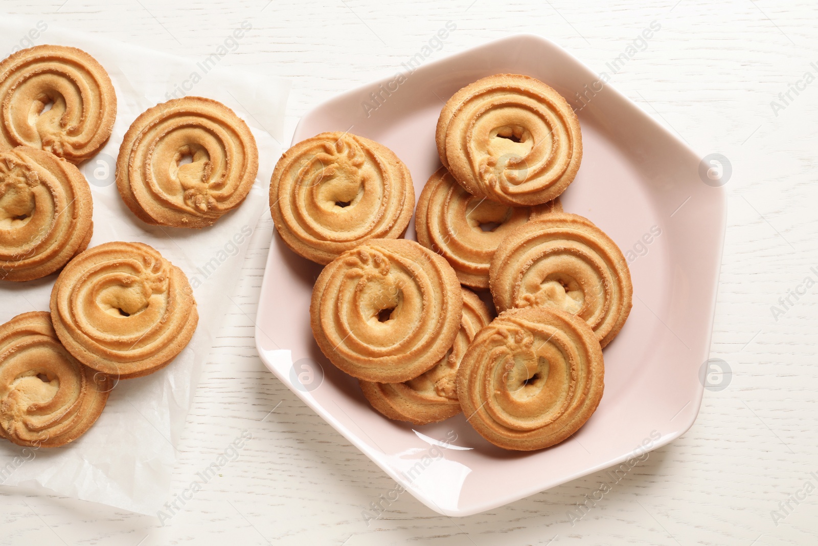 Photo of Flat lay composition with Danish butter cookies on wooden table