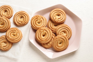 Photo of Flat lay composition with Danish butter cookies on wooden table