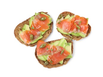 Delicious sandwiches with salmon, avocado and capers on white background, top view