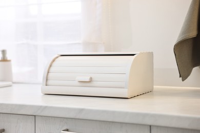 Photo of Wooden bread box on white countertop in kitchen