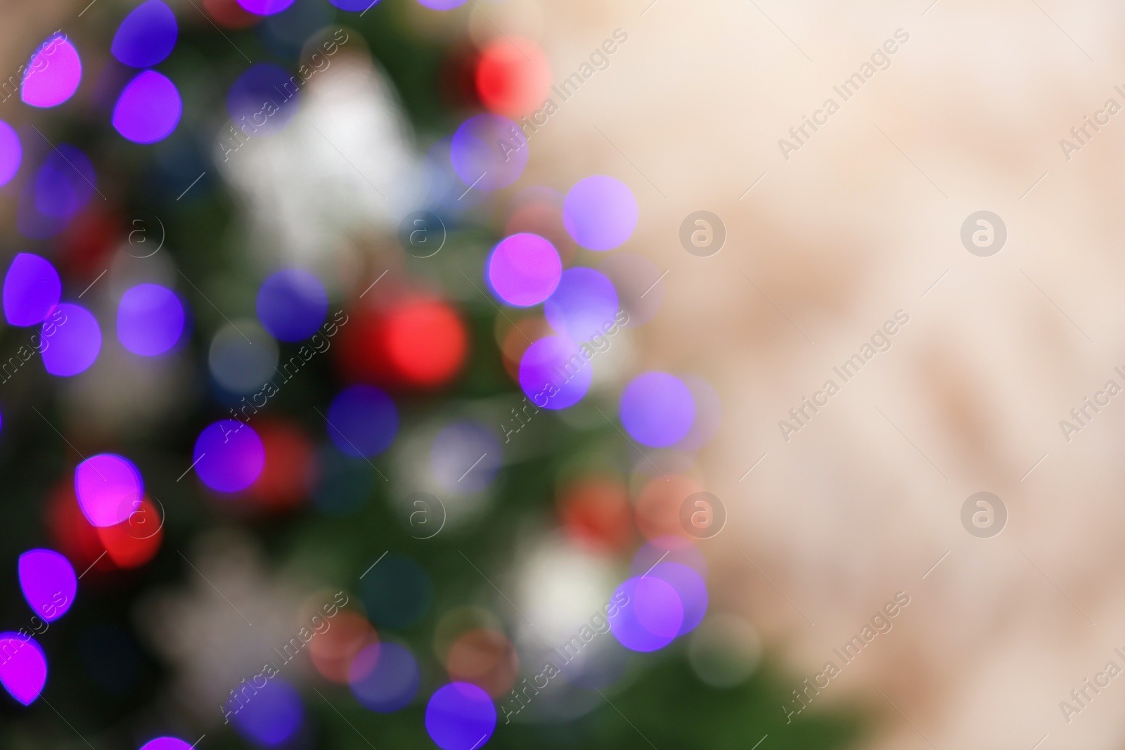 Photo of Beautiful Christmas tree with lights against brown background, blurred view. Space for text