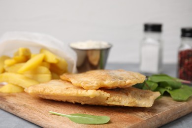 Delicious fish and chips with mangold on table, closeup