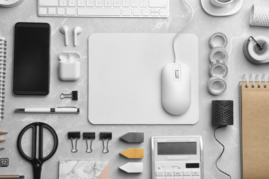 Photo of Flat lay composition with wired computer mouse and stationery on light grey table. Space for text