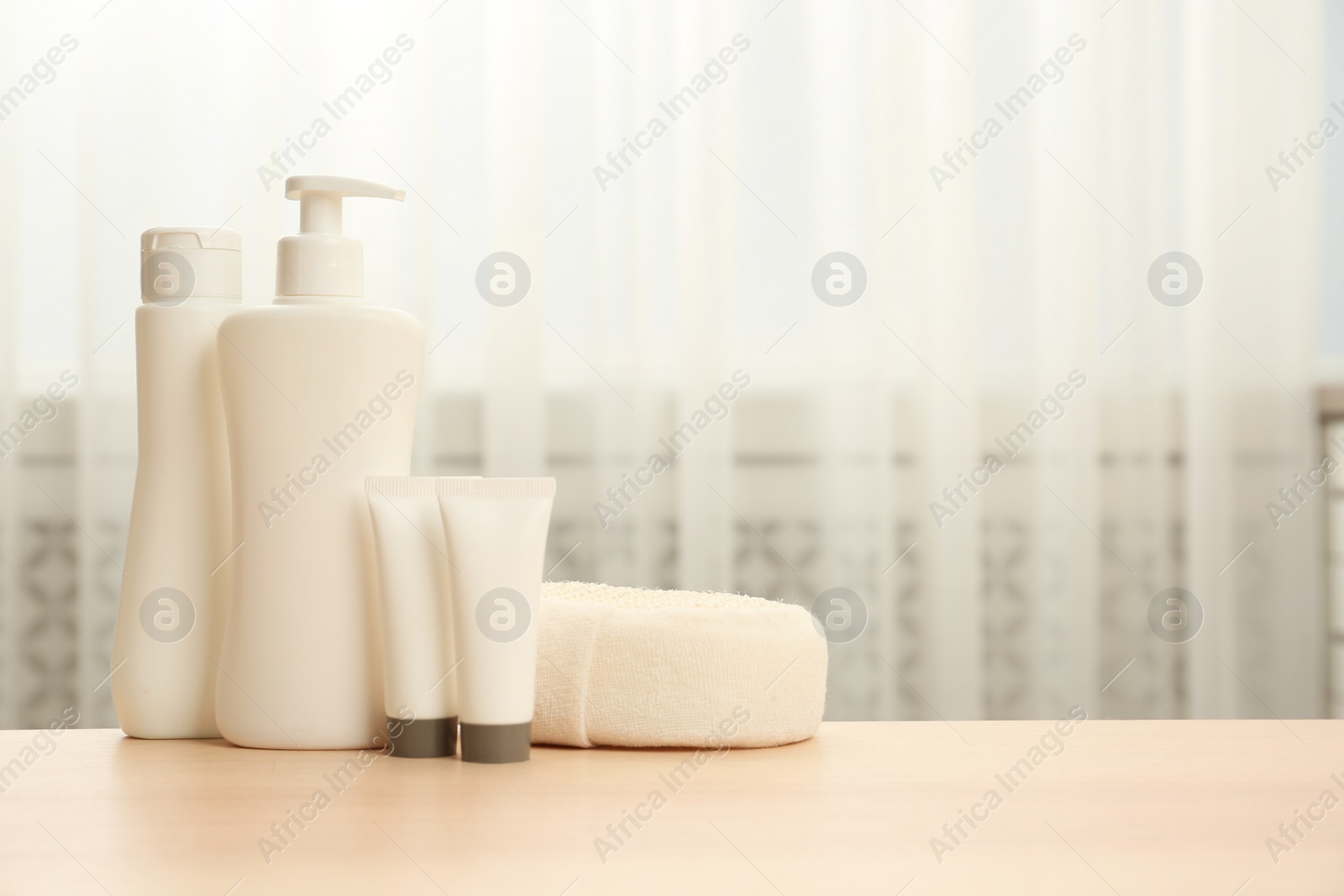 Photo of Baby cosmetic products and accessories on wooden table indoors. Space for text