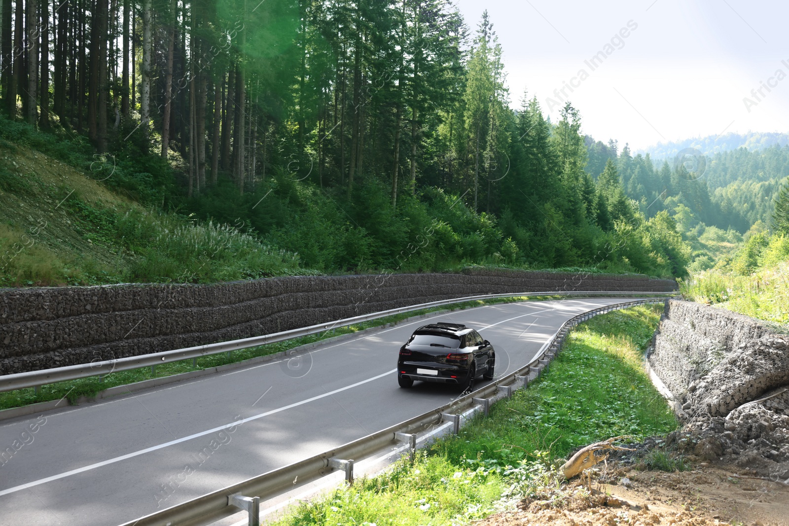 Photo of Picturesque view of asphalt road with modern car outdoors