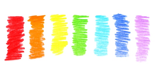 Photo of Rainbow drawn with colorful pencils on white background, top view
