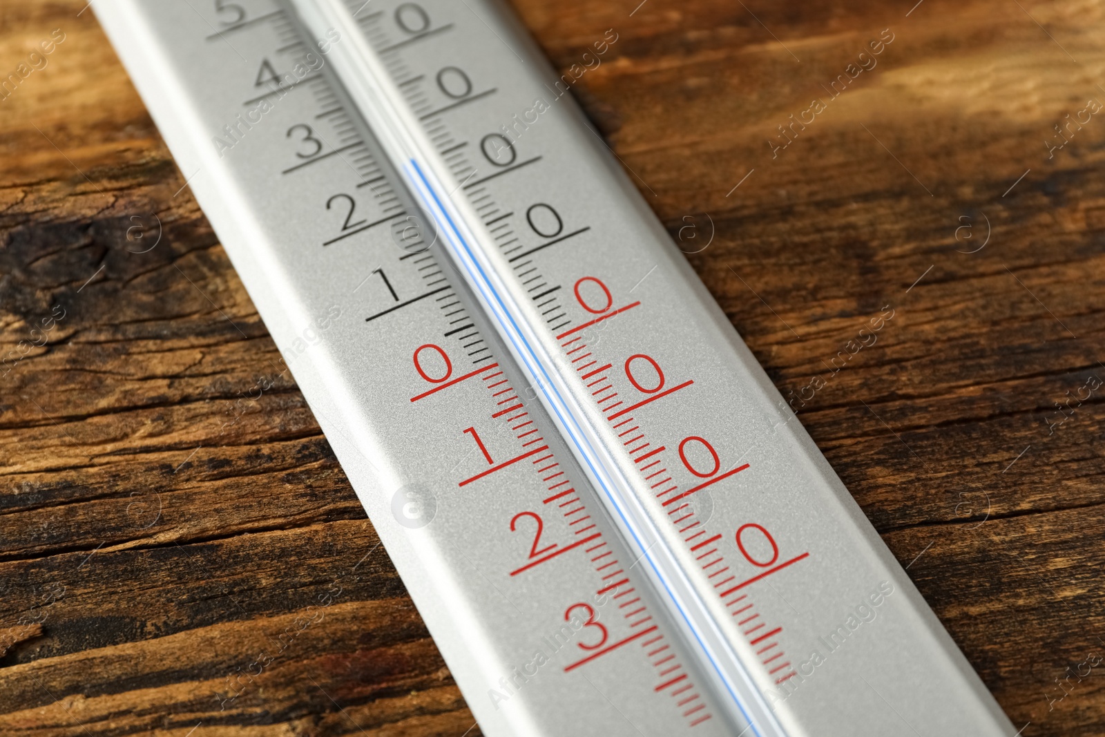 Photo of Modern weather thermometer on wooden background, closeup