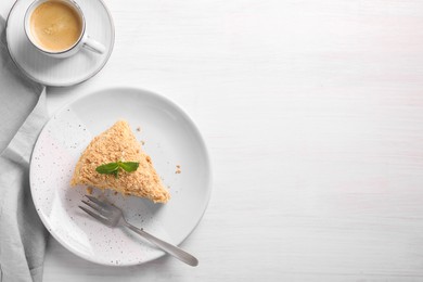 Photo of Delicious Napoleon cake served on white wooden table, flat lay. Space for text