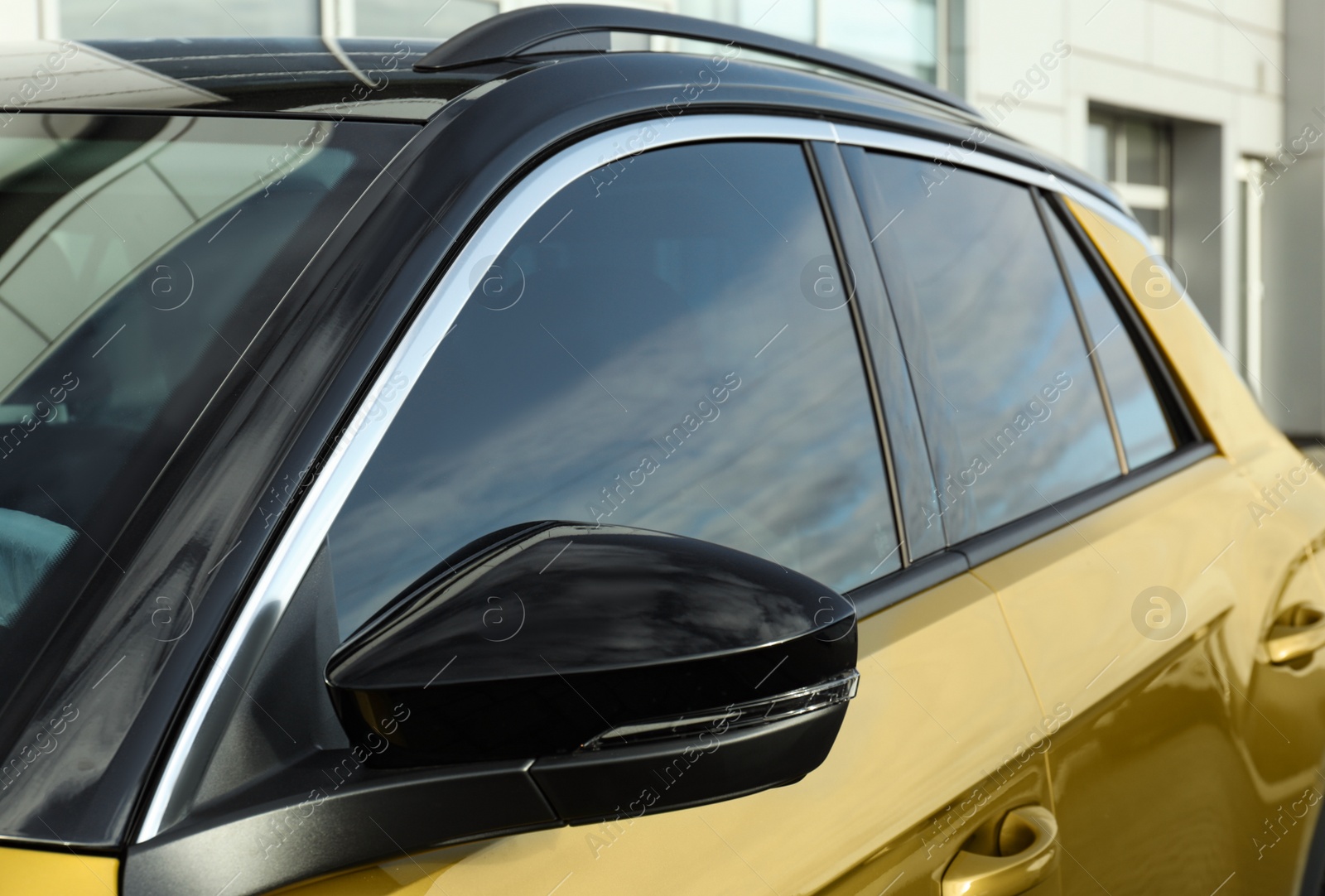 Photo of Modern car with tinting foil on window outdoors, closeup