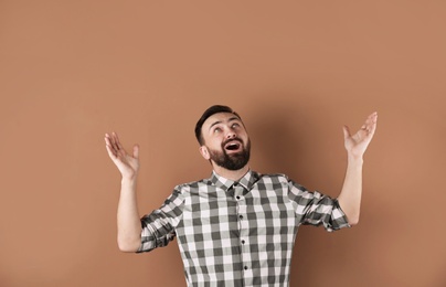 Photo of Portrait of handsome bearded man on color background