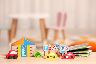 Set of wooden toys on table indoors, space for text. Children's development