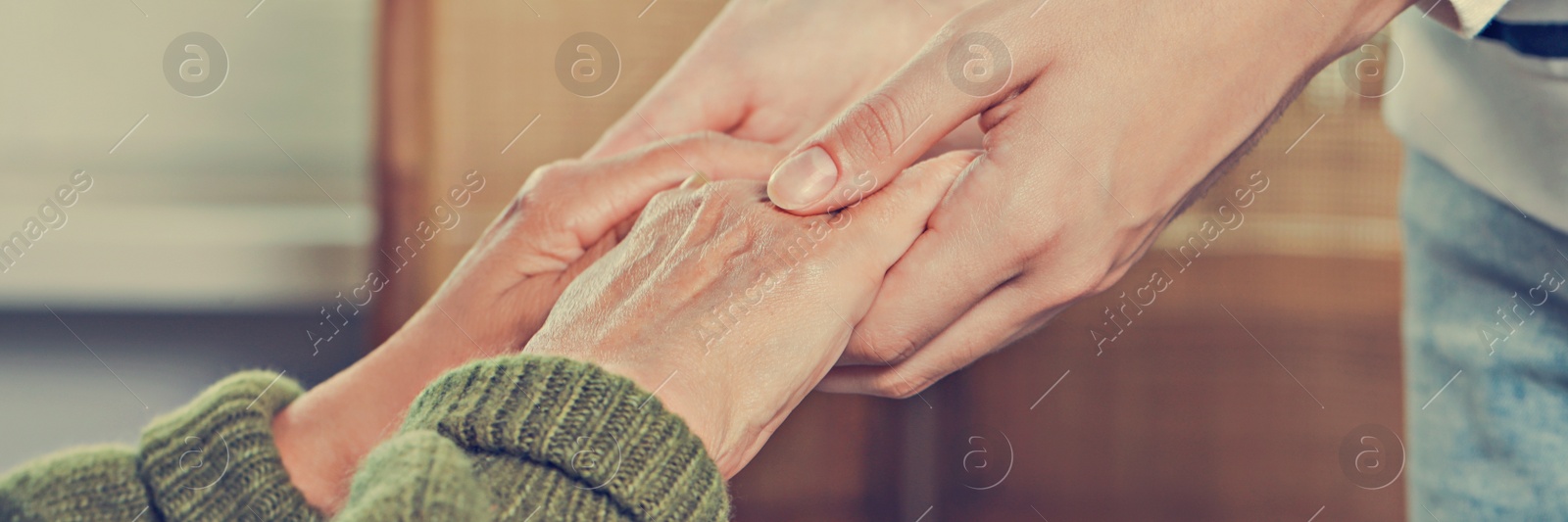 Image of Caregiver helping elderly woman at home, closeup. Banner design