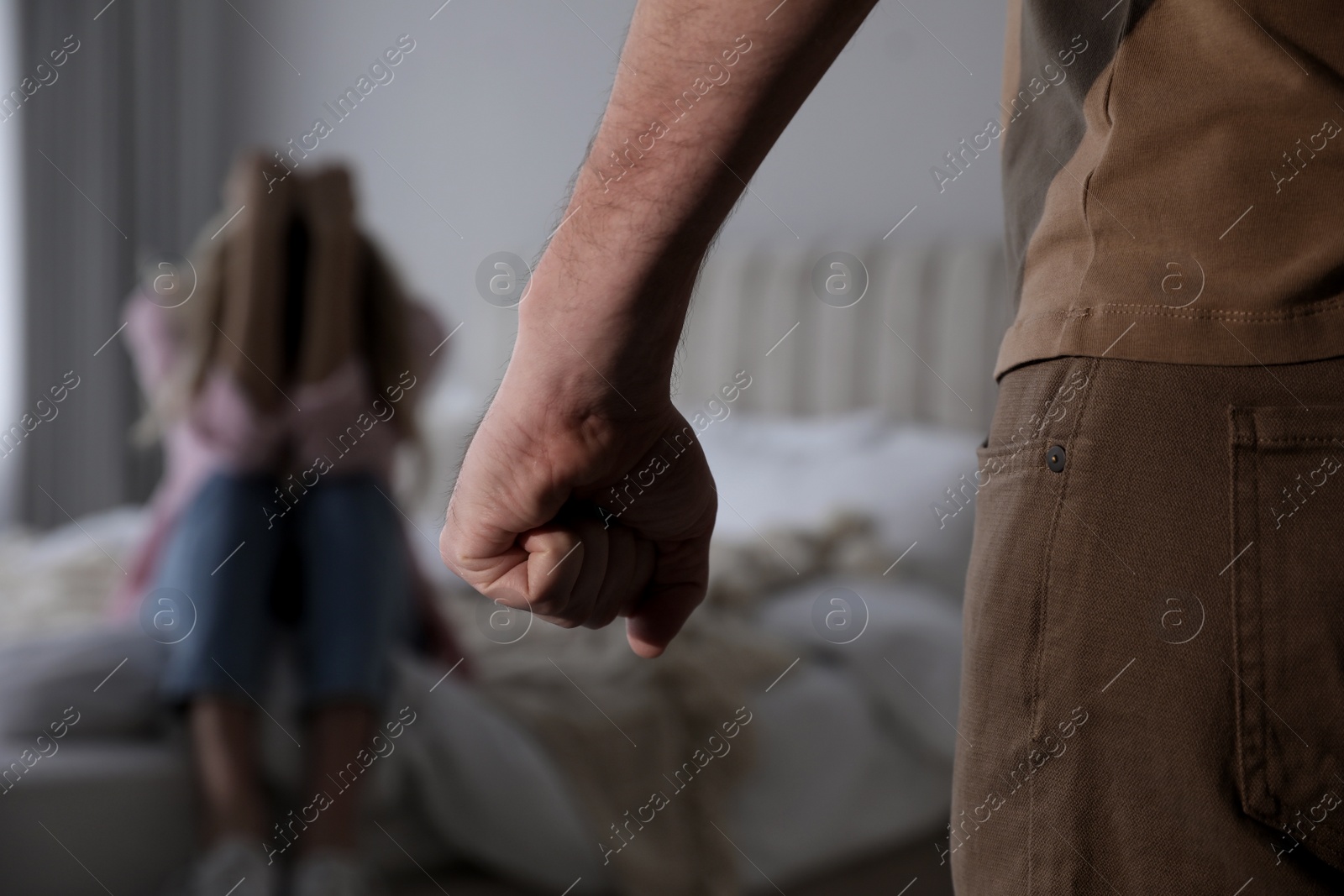 Photo of Man threatening scared woman at home, closeup. Domestic violence